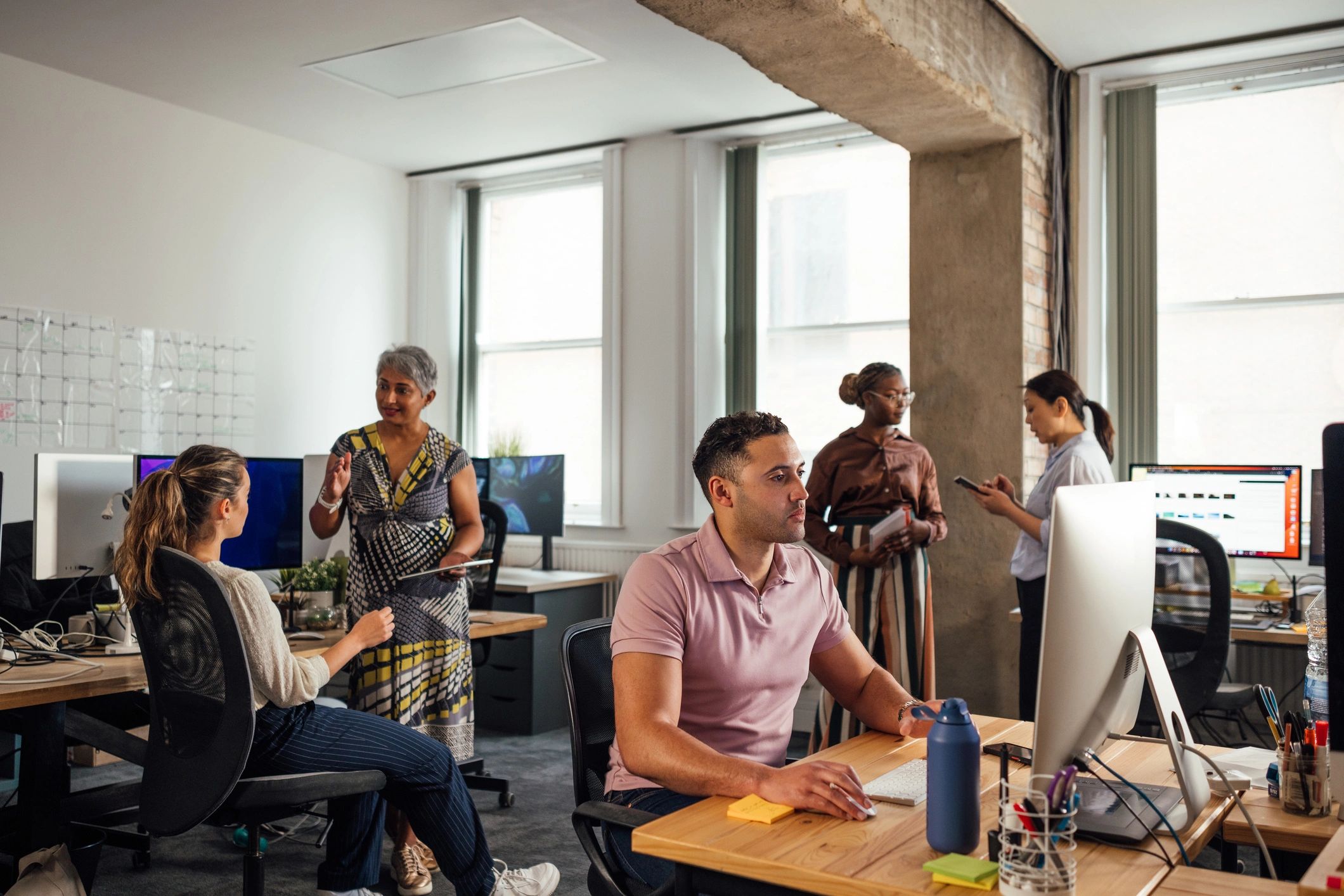 Amara Information Technology team working in a modern office