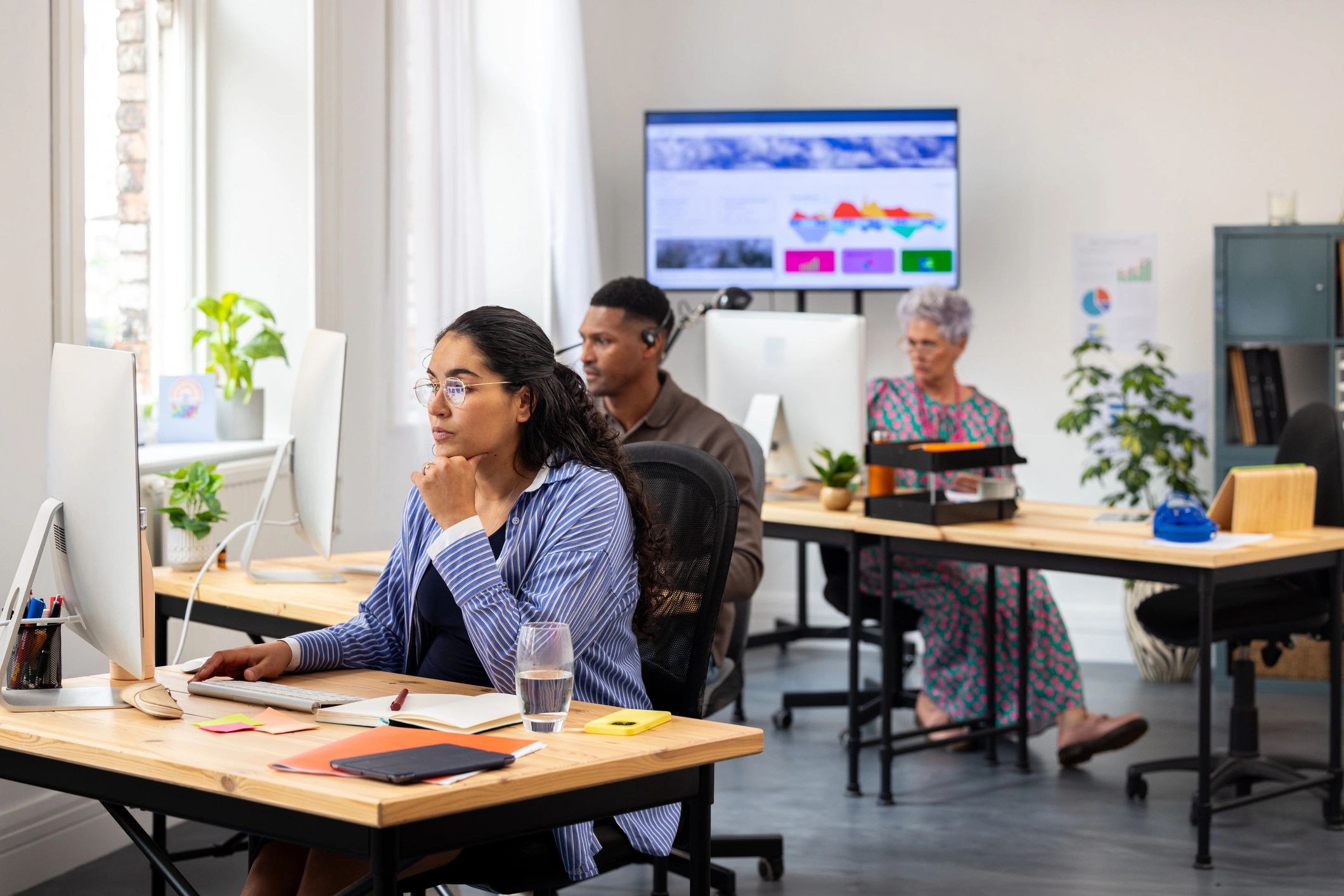 Data-driven office environment with team members at work